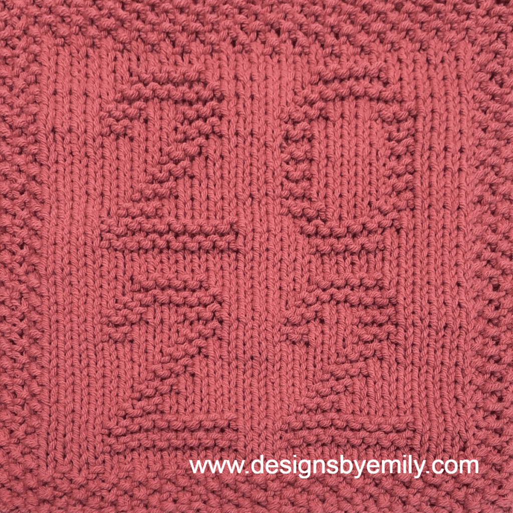 2022 Knit Dishcloth: A handmade knitted dishcloth square in green with the numbers 2022 arranged in a square with 20 on top and 22 underneath. The design is created using knit and purl stitches.