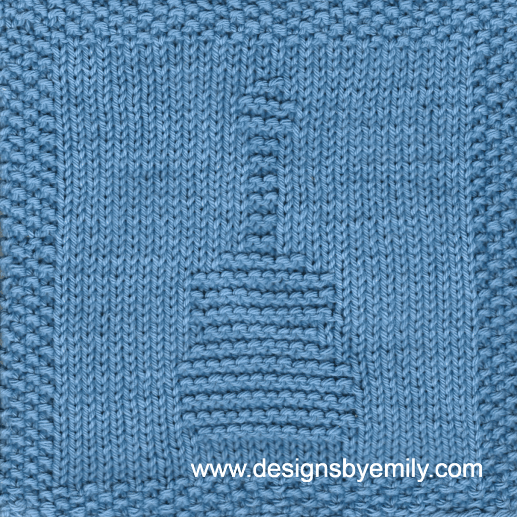 Acoustic Guitar Knit Dishcloth: A handmade knitted dishcloth square in blue yarn displaying a design of an upright acoustic guitar in the center. The design is created using knit and purl stitches.