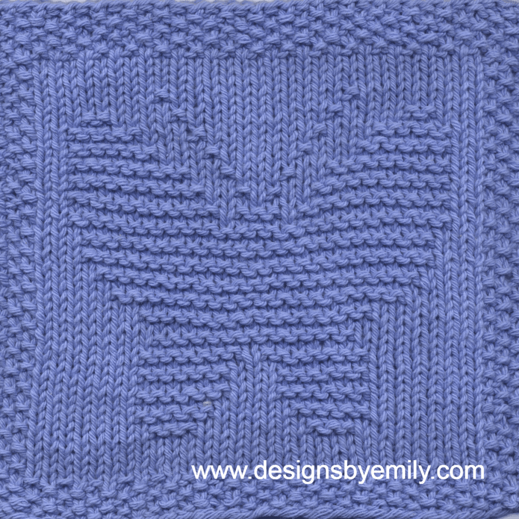 Butterfly Knit Dishcloth: A handmade knit dishcloth square in purple yarn featuring a butterfly in the center with its wings spread wide. The design is created in garter stitch using knit and purl stitches on a stockinette background.