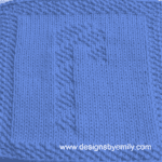 Candy Cane Knit Dishcloth: A handmade knit dishcloth square in blue yarn featuring a striped candy cane. The design is created in seed stitch using knits and purls on a stockinette background.