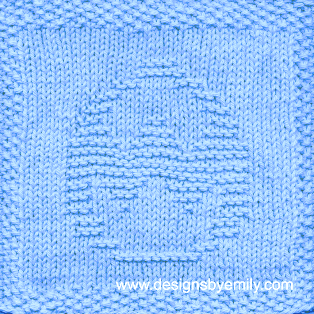 Easter Egg with Rickrack Knit Dishcloth: A handmade knitted dishcloth square in blue yarn displaying an Easter egg decorated with zig-zag rickrack. The design is created in garter stitch using knit and purl stitches on a stockinette background.