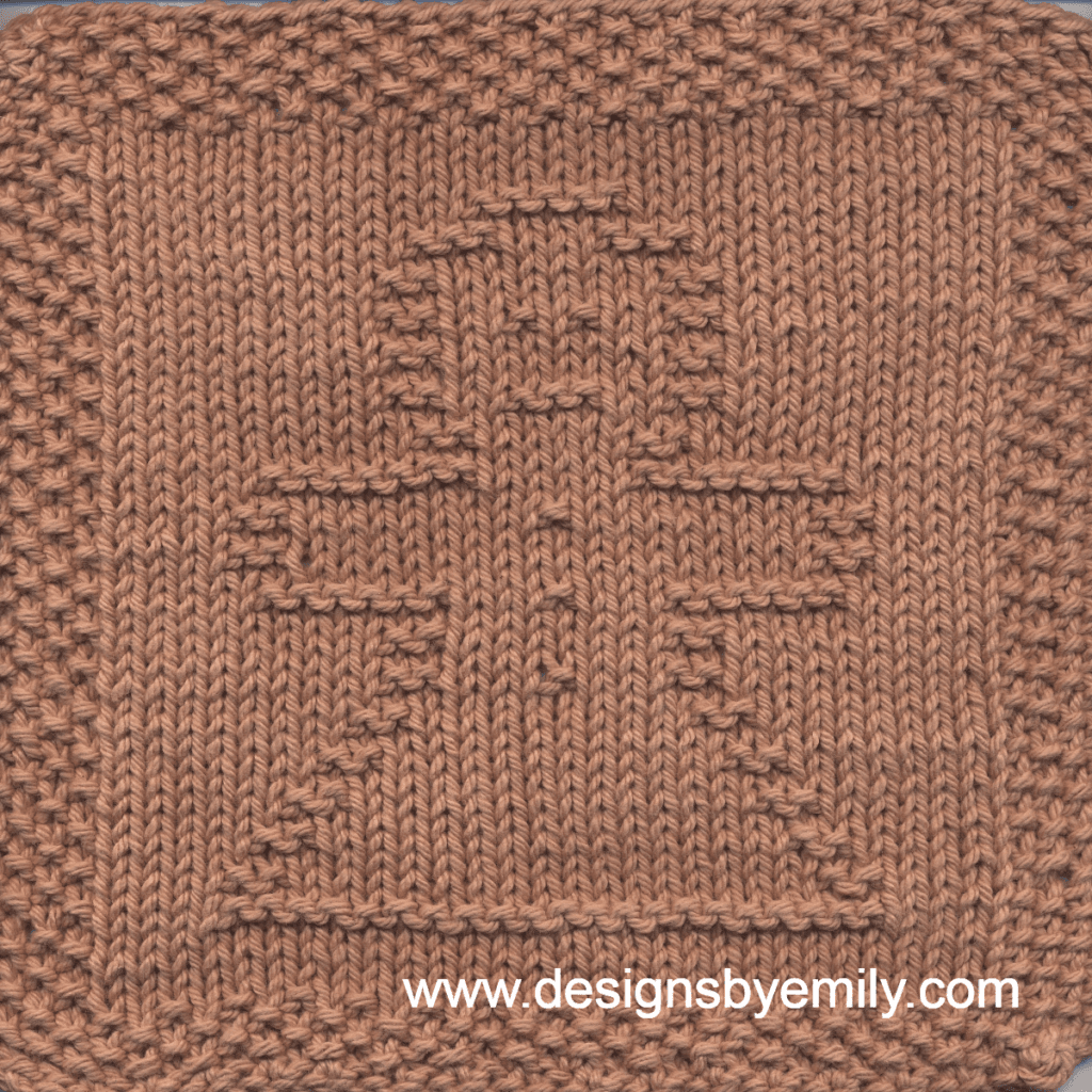 Gingerbread Girl Knit Dishcloth: A cozy knitted dishcloth square in brown yarn featuring a cheerful gingerbread girl in the center, perfect for holiday decor. The design is created in garter stitch using knit and purl stitches on a stockinette background.