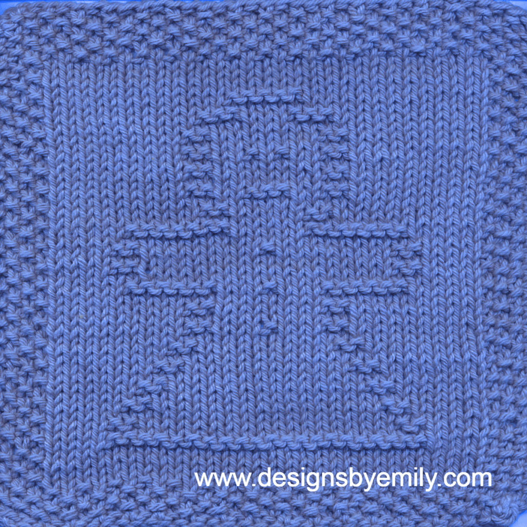 Gingerbread Girl Knit Dishcloth: A cozy knitted dishcloth square in blue yarn featuring a cheerful gingerbread girl in the center, perfect for holiday decor. The design is created in garter stitch using knit and purl stitches on a stockinette background.