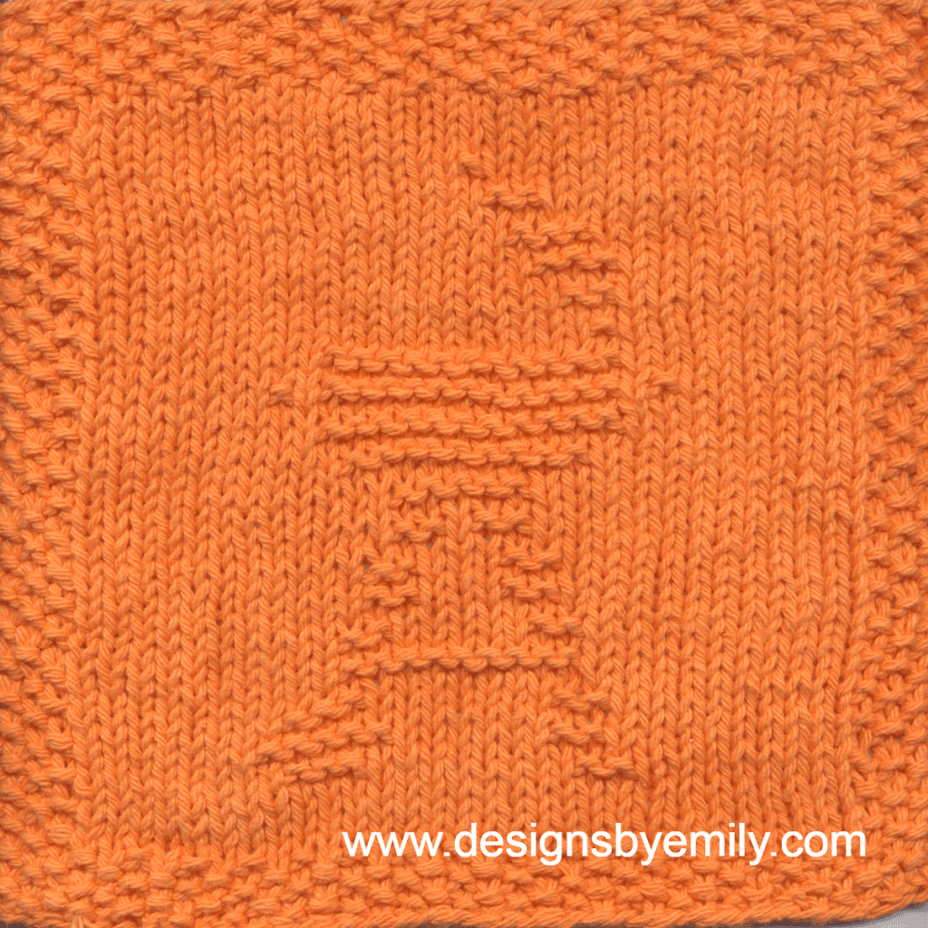 Charcoal Grill Knit Dishcloth: A handmade knit dishcloth square in orange yarn featuring a round charcoal grill on a wheeled stand with its lid open. The design is created in garter stitch using knit and purl stitches on a stockinette background.