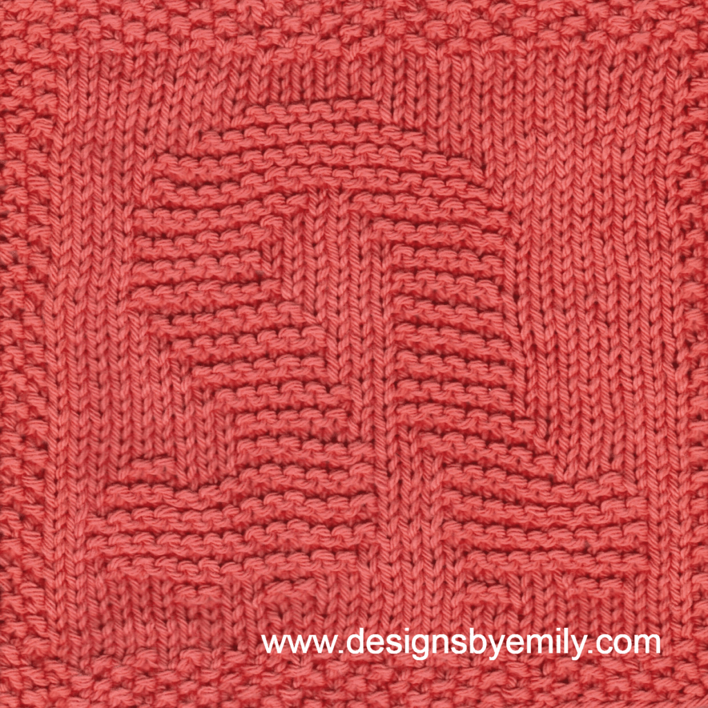Inchworm Knit Dishcloth: A handmade knit dishcloth square in coral yarn featuring an adorable inchworm bunched up with his front and back ends close together. The design is created in garter stitch using knit and purl stitches on a stockinette background.