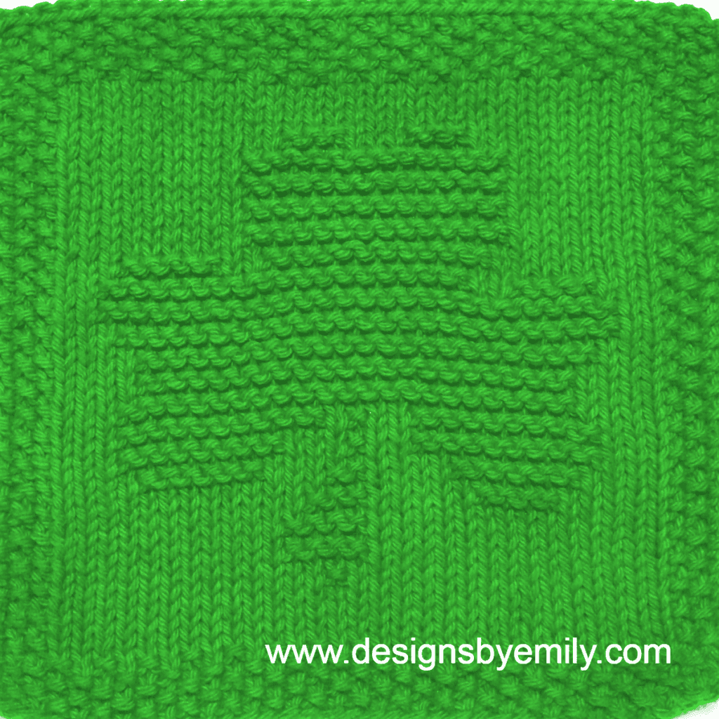 Shamrock Knit Dishcloth: A handmade knitted dishcloth square in bright kelly green yarn featuring a three-leaf shamrock. The design is created using knit and purl stitches.