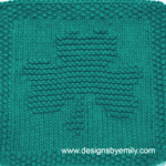 Shamrock Knit Dishcloth: A handmade knitted dishcloth square in teal yarn featuring a three-leaf shamrock. The design is created using knit and purl stitches.