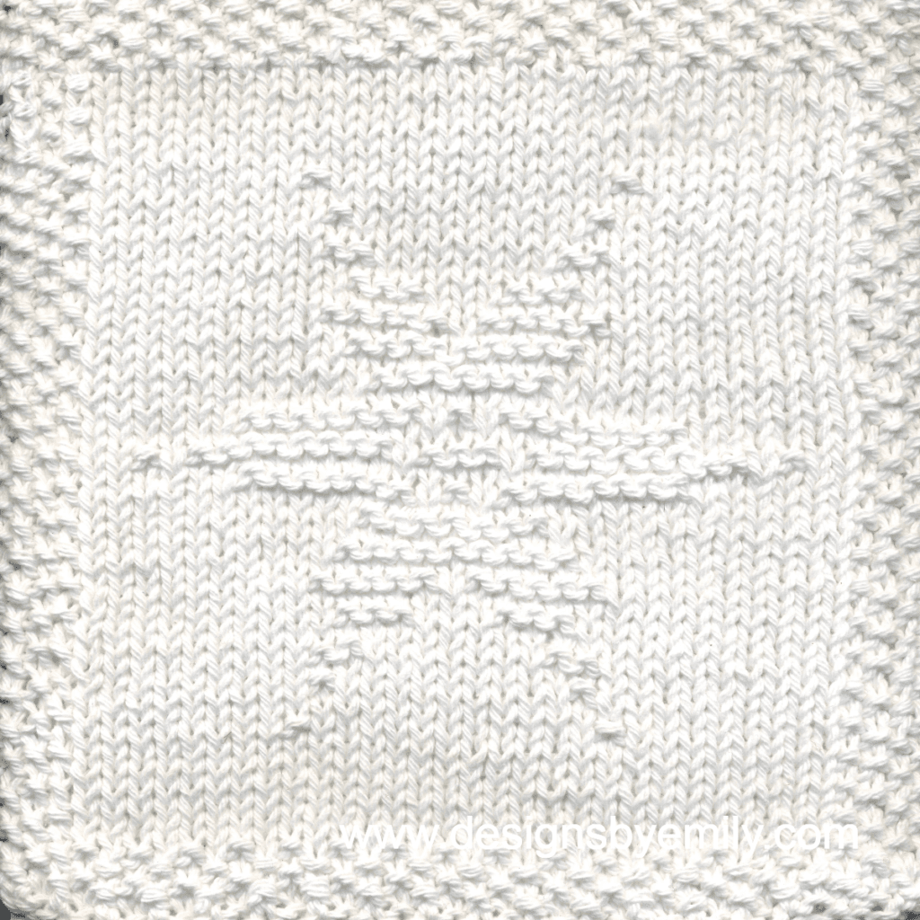 Snowflake Knit Dishcloth: A handmade knitted dishcloth square in white yarn adorned with a six-pointed snowflake in the center. The design is created using knit and purl stitches.