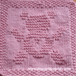 Teddy Bear Love Knit Dishcloth: A handmade knitted dishcloth square in light pink yarn featuring a cute teddy bear with its arms and legs spread out and a heart on its belly. The design is created in garter stitch using knit and purl stitches on a stockinette background.