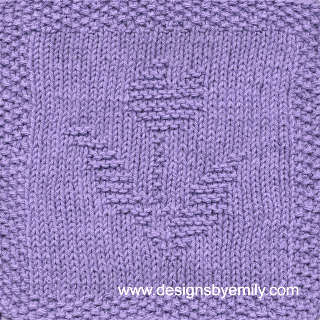 Tulip Knit Dishcloth: A handmade knitted dishcloth square in purple yarn displaying a single tulip with its distinctive leaves to each side. The design is created using knit and purl stitches.