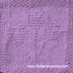 Tulip Trio Knit Dishcloth: A handmade knitted dishcloth square in lilac yarn displaying three tulips sprouting from the center. The design is created using knit and purl stitches.