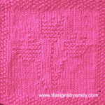 Tulip Trio Knit Dishcloth: A handmade knitted dishcloth square in hot pink yarn displaying three tulips sprouting from the center. The design is created using knit and purl stitches.